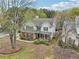 Aerial view of a two-story home with a well-manicured lawn and landscaped yard at 4845 Weathervane Dr, Alpharetta, GA 30022
