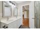 This bathroom features double sinks, gray cabinets, and neutral paint at 4845 Weathervane Dr, Alpharetta, GA 30022