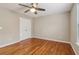 The bedroom features hardwood floors, neutral paint, and a ceiling fan at 4845 Weathervane Dr, Alpharetta, GA 30022