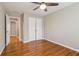 Bedroom with hardwood floors, a ceiling fan, and a closet at 4845 Weathervane Dr, Alpharetta, GA 30022
