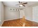 This bedroom features hardwood floors, a ceiling fan, and a built-in shelf at 4845 Weathervane Dr, Alpharetta, GA 30022