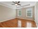 Spacious bedroom features hardwood floors, a tray ceiling, and natural light from two windows at 4845 Weathervane Dr, Alpharetta, GA 30022