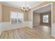 Elegant dining room with natural light, chandelier, and hardwood floors, perfect for entertaining at 4845 Weathervane Dr, Alpharetta, GA 30022