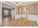 Dining area featuring hardwood floors, wainscoting, and elegant lighting, perfect for entertaining and Gathering meals at 4845 Weathervane Dr, Alpharetta, GA 30022