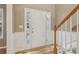 Bright entryway with paneled walls, hardwood floors, and sidelights flanking the front door at 4845 Weathervane Dr, Alpharetta, GA 30022