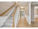 Inviting entryway with hardwood floors, staircase, and elegant trim, creating a warm and welcoming ambiance at 4845 Weathervane Dr, Alpharetta, GA 30022
