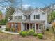 Attractive two-story home featuring a brick facade, well-maintained lawn, and classic architectural details at 4845 Weathervane Dr, Alpharetta, GA 30022