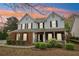 Charming two-story home with a brick facade, inviting front porch, and beautifully landscaped front yard at 4845 Weathervane Dr, Alpharetta, GA 30022