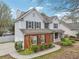 Traditional two-story home featuring a brick facade, attached garage, and neatly landscaped front yard at 4845 Weathervane Dr, Alpharetta, GA 30022