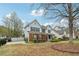 Charming two-story home in a well-maintained community featuring a manicured front lawn and mature trees at 4845 Weathervane Dr, Alpharetta, GA 30022