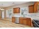 View of the kitchen showing the open floor plan, stainless dishwasher, and natural light at 4845 Weathervane Dr, Alpharetta, GA 30022