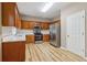 Updated kitchen with stainless steel appliances, wood cabinets, and light countertops, perfect for cooking at 4845 Weathervane Dr, Alpharetta, GA 30022