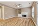 Inviting living room with hardwood floors, fireplace, built-in shelving, and ample natural light at 4845 Weathervane Dr, Alpharetta, GA 30022