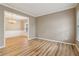 Open living room with hardwood floors, neutral paint, and adjacent dining area for entertaining at 4845 Weathervane Dr, Alpharetta, GA 30022