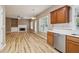 View of the living room from the kitchen, showing the open floor plan and natural light at 4845 Weathervane Dr, Alpharetta, GA 30022