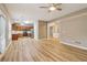 Open-concept living area showcasing hardwood floors, modern lighting, and seamless flow between the kitchen and living spaces at 4845 Weathervane Dr, Alpharetta, GA 30022
