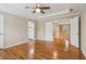 This main bedroom features hardwood floors, ceiling fan, and neutral paint at 4845 Weathervane Dr, Alpharetta, GA 30022