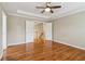 This main bedroom boasts hardwood floors, a ceiling fan, and neutral paint at 4845 Weathervane Dr, Alpharetta, GA 30022
