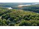 Aerial view of a house nestled among lush, mature trees with a beautiful lake view at 525 Sycamore Pt, Woodstock, GA 30189