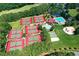 An aerial view of community amenities, including multiple tennis courts, a swimming pool, and playground for recreation at 525 Sycamore Pt, Woodstock, GA 30189