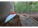 Charming backyard features a stone walkway and wooded views, enhancing the home's natural appeal at 525 Sycamore Pt, Woodstock, GA 30189