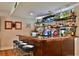 Basement boasts a custom wet bar with a wide selection of spirits and seating at 525 Sycamore Pt, Woodstock, GA 30189