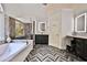 Elegant bathroom with soaking tub, glass shower, double vanity, and herringbone floors at 525 Sycamore Pt, Woodstock, GA 30189