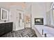 Beautiful bathroom with soaking tub, fireplace, herringbone floors, and modern vanity at 525 Sycamore Pt, Woodstock, GA 30189
