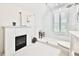 Clean, bright bathroom featuring a tiled shower, toilet and a small fireplace heater at 525 Sycamore Pt, Woodstock, GA 30189