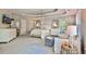 Bright bedroom features a trey ceiling, large windows, and a cozy seating area at 525 Sycamore Pt, Woodstock, GA 30189