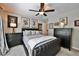 Bedroom with black leather-tufted headboard, matching dressers, and a ceiling fan with a light at 525 Sycamore Pt, Woodstock, GA 30189