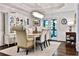 Elegant dining room with a crystal chandelier, classic furnishings, and ample seating at 525 Sycamore Pt, Woodstock, GA 30189