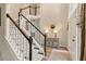 Inviting foyer with hardwood floors, staircase, and stylish console table beneath a mirror at 525 Sycamore Pt, Woodstock, GA 30189