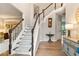 Elegant foyer with staircase, hardwood floors, and stylish decor at 525 Sycamore Pt, Woodstock, GA 30189