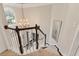 Grand foyer featuring a staircase, hardwood floors, a chandelier and a view of the living room at 525 Sycamore Pt, Woodstock, GA 30189