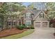 Beautiful two-story home with a combination of stone and stucco, and a two car garage at 525 Sycamore Pt, Woodstock, GA 30189