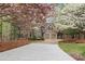 Beautiful home with flowering trees in the front yard and a long, patterned driveway at 525 Sycamore Pt, Woodstock, GA 30189