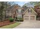 Charming two-story home with a stone and stucco facade, complemented by a well-manicured front yard at 525 Sycamore Pt, Woodstock, GA 30189