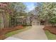 Two-story home with stucco and stone exterior, mature trees, and an inviting driveway at 525 Sycamore Pt, Woodstock, GA 30189