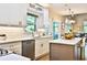 Well-lit kitchen with white subway tile, stainless appliances, and an island open to the dining area at 525 Sycamore Pt, Woodstock, GA 30189