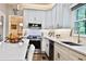 Bright kitchen featuring white cabinetry, quartz countertops, and modern fixtures at 525 Sycamore Pt, Woodstock, GA 30189