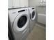 A well lit laundry room with a Whirlpool washer and dryer at 525 Sycamore Pt, Woodstock, GA 30189