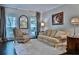 Cozy living room featuring a plush rug, elegant seating, and abundant natural light at 525 Sycamore Pt, Woodstock, GA 30189
