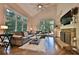Inviting living room with large windows, comfortable seating, and a stone fireplace at 525 Sycamore Pt, Woodstock, GA 30189