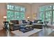 Bright living room with large windows offering serene views of the surrounding trees at 525 Sycamore Pt, Woodstock, GA 30189