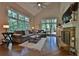Bright living room features hardwood floors, large windows with wooded views, and a stone fireplace at 525 Sycamore Pt, Woodstock, GA 30189