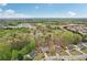 An aerial view of homes surrounded by trees, a pond, and green space in a residential neighborhood at 1145 Prospect Mill Dr, Lawrenceville, GA 30043