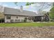 Backyard featuring a sunroom, lush green lawn and a decorative rock garden at 1145 Prospect Mill Dr, Lawrenceville, GA 30043