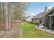Landscaped backyard featuring a stone path, a screened-in porch on a gray house, and a well-maintained lawn at 1145 Prospect Mill Dr, Lawrenceville, GA 30043