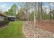 Backyard with screened porch, stone landscaping, and mature trees at 1145 Prospect Mill Dr, Lawrenceville, GA 30043